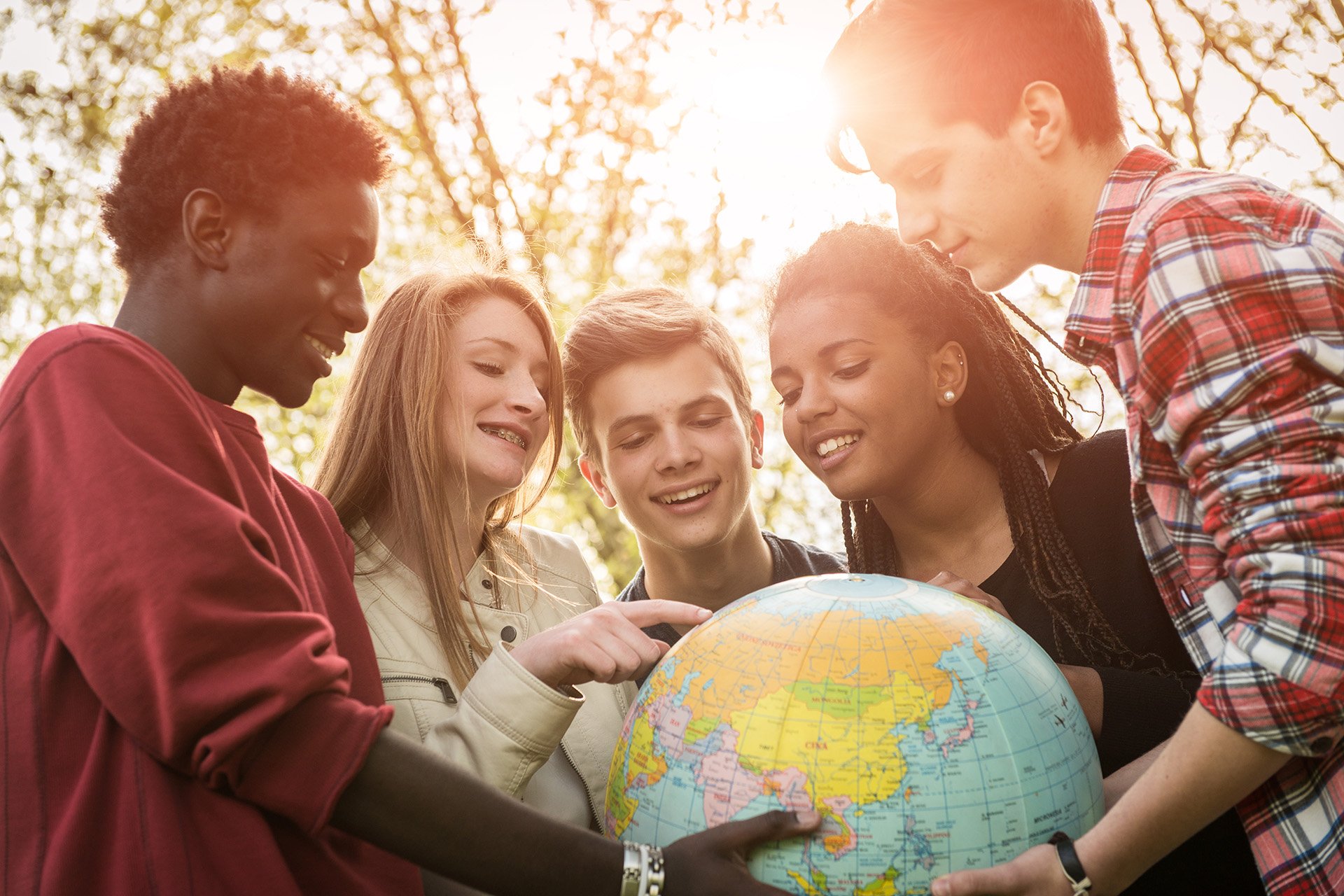 Multiracial Teen Couple Holding Globe Map - stock